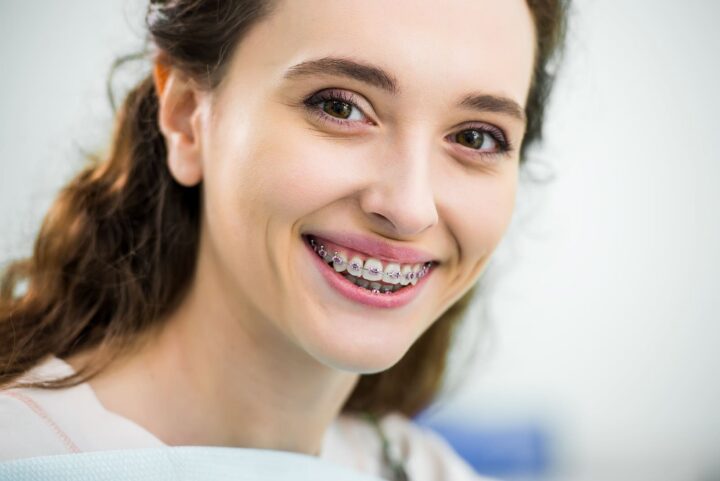 Adult patient smiling with braces